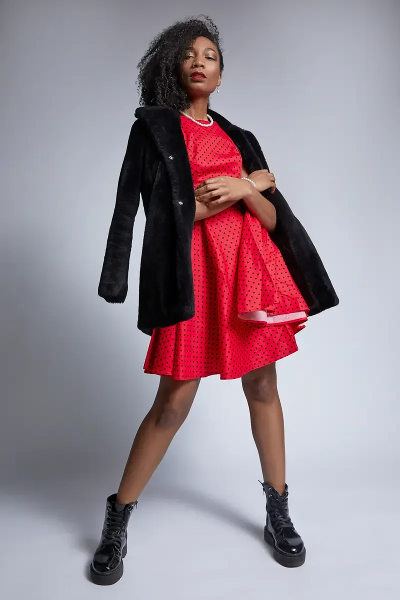 Arielle Chambers, full length, red polka dot dress and black faux fur coat, pearl necklace, platform boots, East Williamsburg studio test shoot, makeup by Schanica Pickens, photographed by Scott Parker Photo