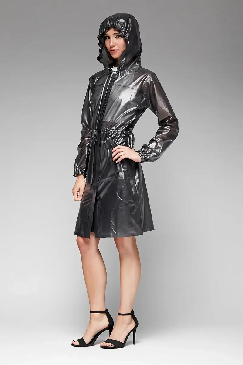 Minika Ko lookbook, gunmetal metallic raincoat, three-quarter view with hood up, center front zip, drawstring waist cinched, elasticated cuffs, high-gloss coated fabric, photographed by Scott Parker Photo