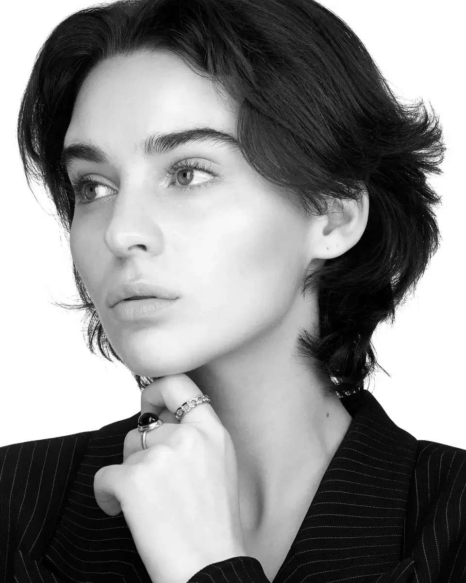 Tess, three-quarter crop, chin resting on hand, black pinstripe blazer, dark oval stone ring and silver band ring, black and white, New York studio test shoot, makeup by Schanica, photographed by Scott Parker Photo