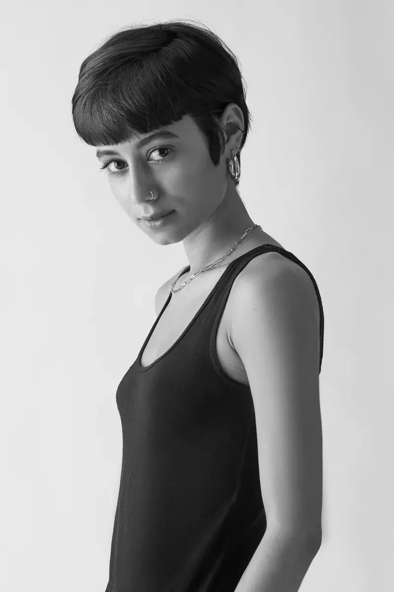 Eloissa, black and white three-quarter profile, black tank, chain necklace, gold hoop earring, East Williamsburg studio test shoot, makeup by Schanica Pickens, photographed by Scott Parker Photo
