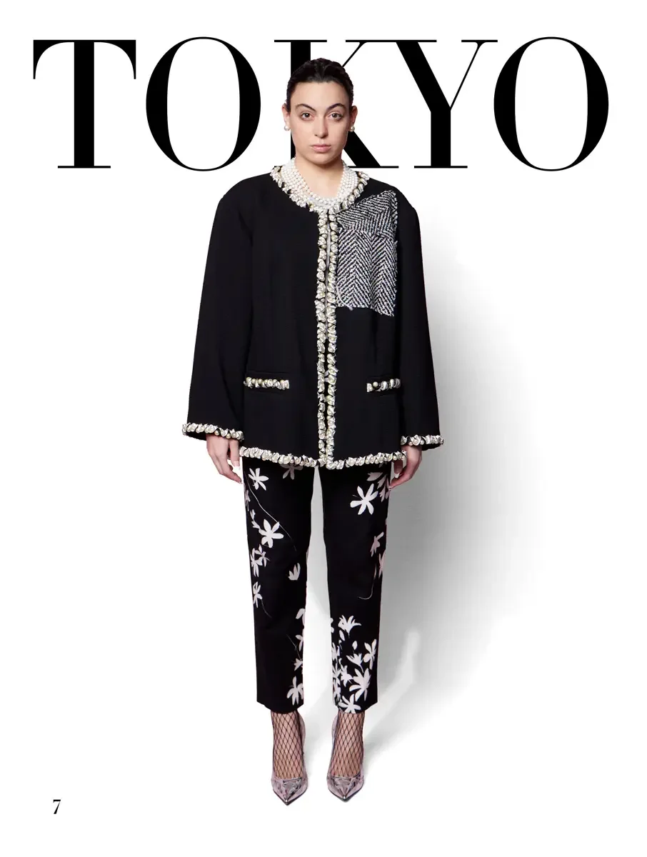 JUS10H 2025 Tokyo lookbook, black collarless jacket with pearl trim and herringbone patch over black floral trousers, white background, photographed by Scott Parker Photo for the Tokyo Fashion Council