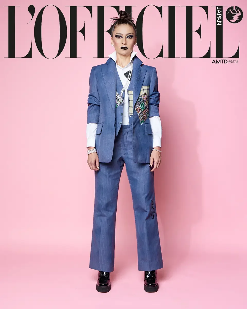 JUS10H 2025 L'Officiel Japan feature, full-length editorial, indigo denim suit with patchwork vest detail, white shirt, patent platform boots, pink background, photographed by Scott Parker Photo