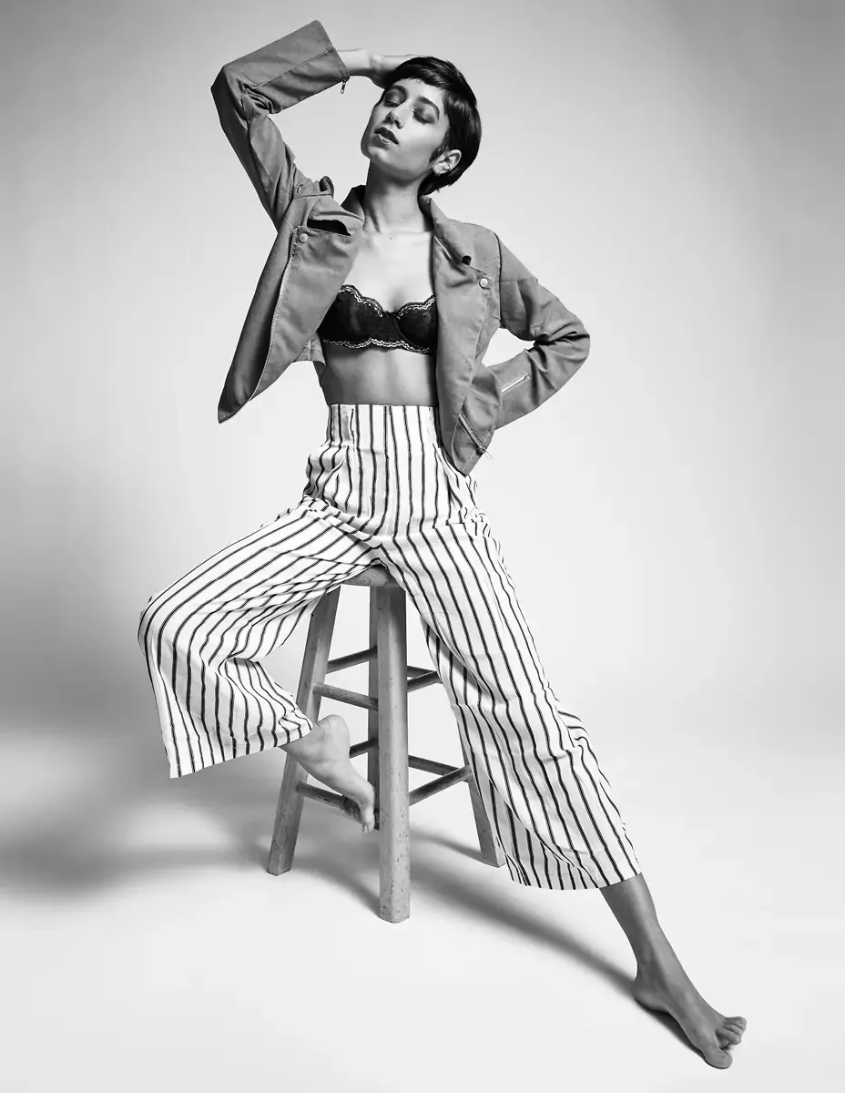 Eloissa, black and white, high-waisted striped wide-leg trousers and tan suede cropped jacket, black lace bralette, studio stool, East Williamsburg studio test shoot, makeup by Schanica Pickens, photographed by Scott Parker Photo