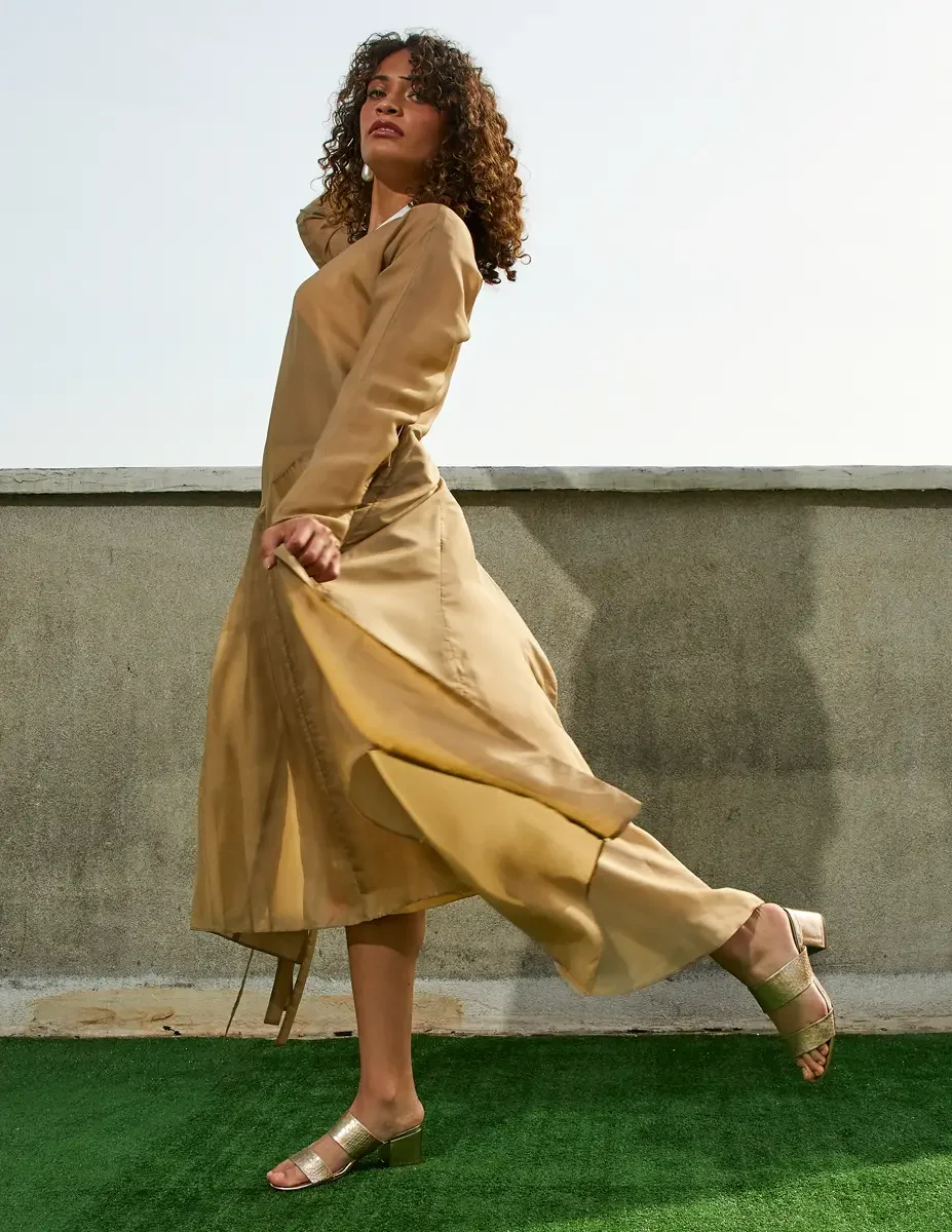 Fashion test shoot, full-length, model Ireland T in a gold satin wrap dress with tie belt, East Village rooftop, New York City, styling by Matsine Stinson, makeup by Stefani Paige Vivian, photographed by Scott Parker Photo