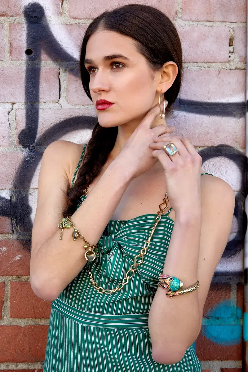 Victoria Henley, gold hoop earring and stacked bracelet detail, green striped jumpsuit, graffiti wall, Los Angeles fashion week test shoot, photographed by Scott Parker Photo