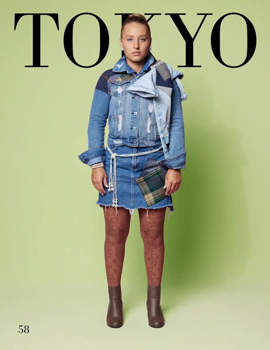 JUS10H 2025 Tokyo lookbook, a female model wearing a distressed light-wash denim trucker jacket with mixed dark denim, plaid, and houndstooth patchwork panels, over a light blue chambray shirt with flared cuffs, a raw-hem light-wash denim mini skirt 