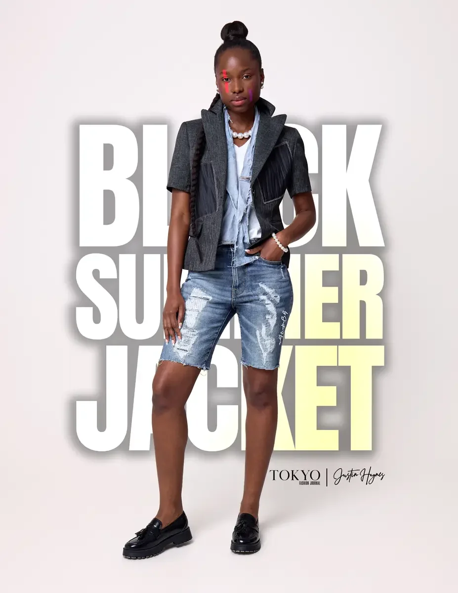JUS10H Black Summer Jacket lookbook, female model in dark denim structured vest layered over light blue denim jacket and white tee, distressed denim bermuda shorts, pearl necklace and bracelet, black loafers, white background, photographed by Scott P