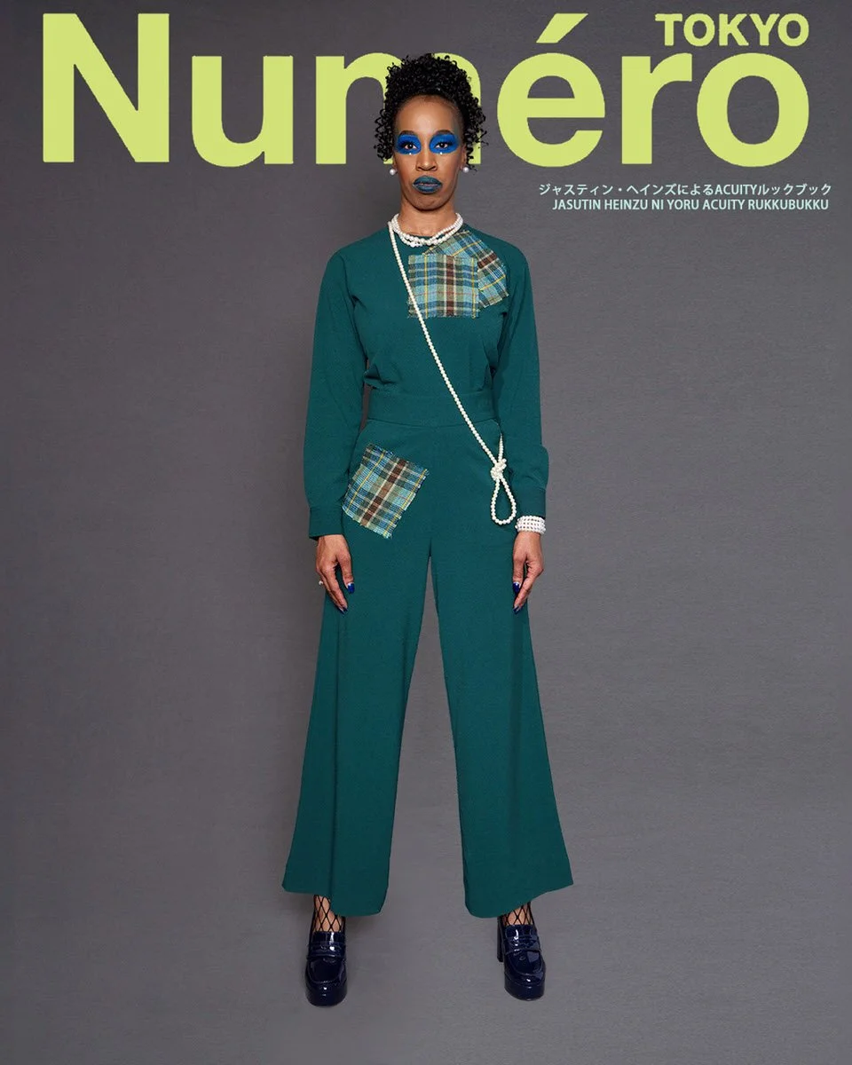 JUS10H by Justin Haynes ACUITY Collection lookbook for Numéro Tokyo by Scott Parker — model in monochromatic teal long-sleeve top and wide-leg trousers with tartan patch detail at chest and hip pocket, layered pearl necklace, fishnet socks, and paten