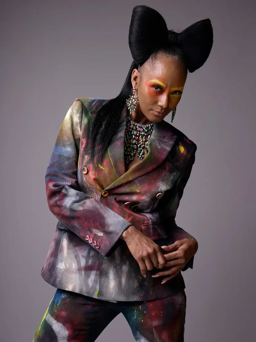 JUS10H Met Monday 2026, three-quarter view hand-painted blazer, iridescent necklace and chandelier earrings, grey background, photographed by Scott Parker Photo