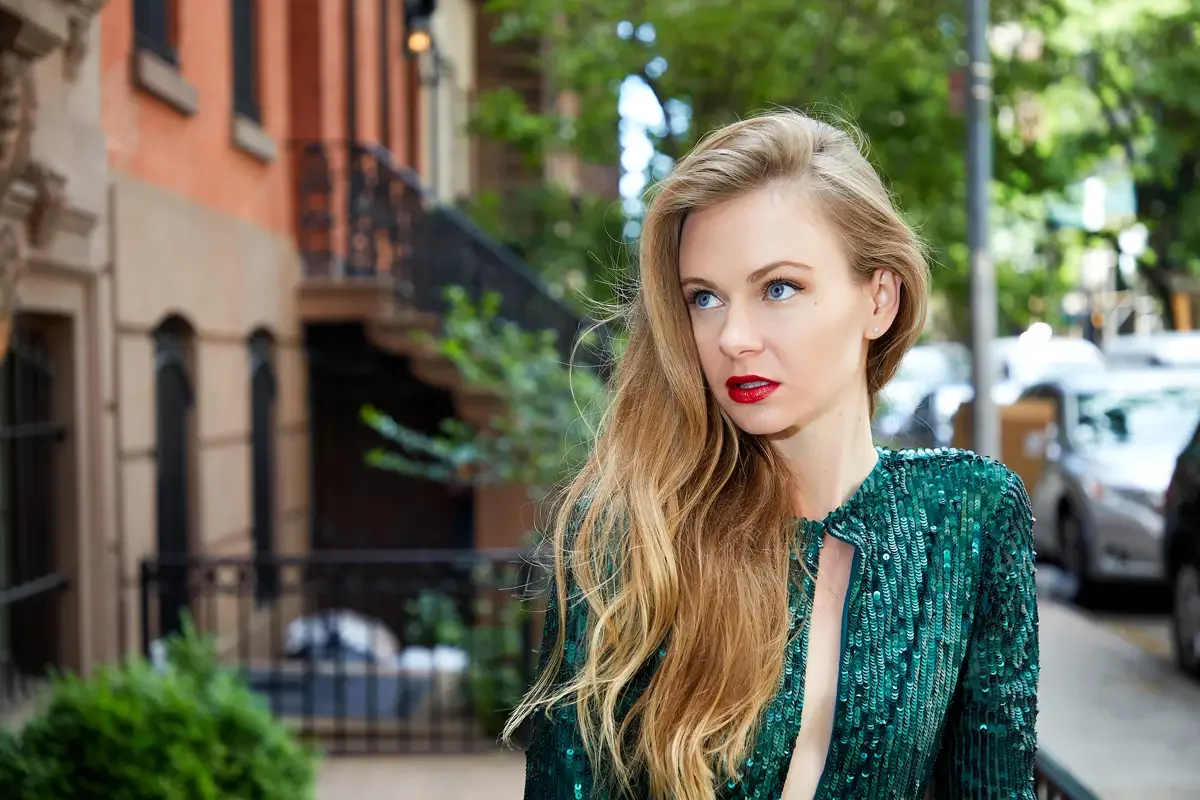 Julia, close-up portrait, emerald green sequin long-sleeve mini dress with keyhole cutout neckline, brownstone buildings and tree-lined street in background, Upper East Side street test shoot, photographed by Scott Parker Photo