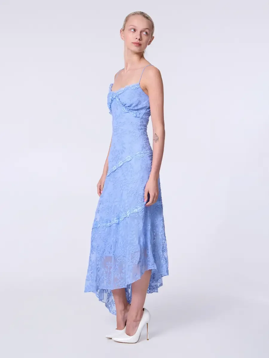 Model portfolio development session, commercial look, periwinkle blue lace asymmetrical midi dress with ruffle bodice detail and spaghetti straps, full-length, three-quarter turn, gaze directed upward, arms relaxed, full length of asymmetrical lace h
