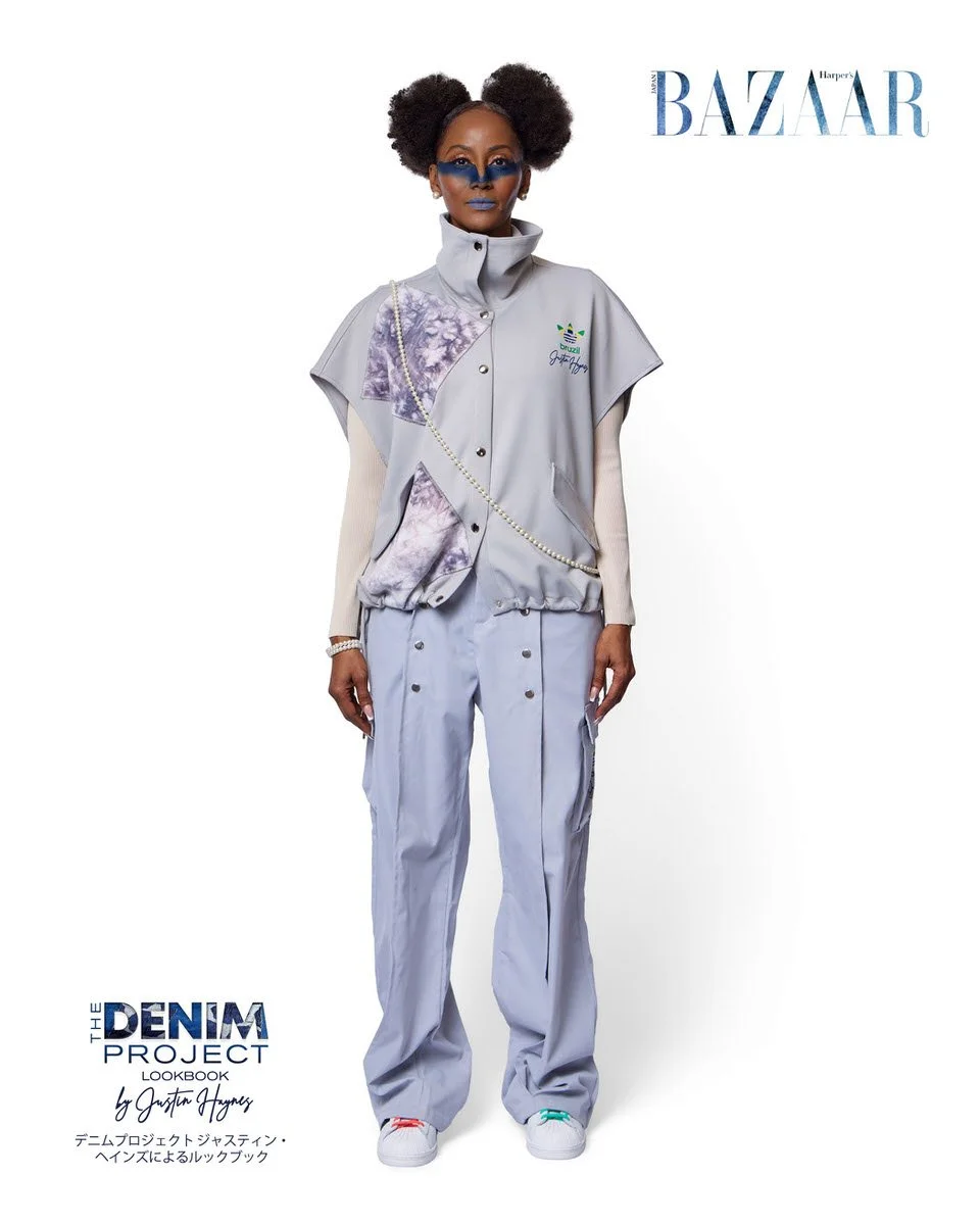 JUS10H Denim Project 2025 Harper's Bazaar Japan lookbook — model in grey sleeveless snap-front track vest with purple tie-dye inset panels and Adidas Brazil x JUS10H branding over white ribbed turtleneck and wide-leg light grey snap-side track trouse