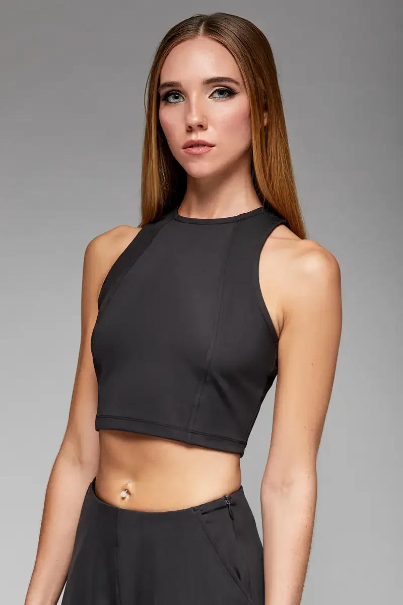 Minika Ko lookbook, detail, black halter crop top, close crop showing high halter neckline, seam construction at front bodice, smooth synthetic fabric, photographed by Scott Parker Photo