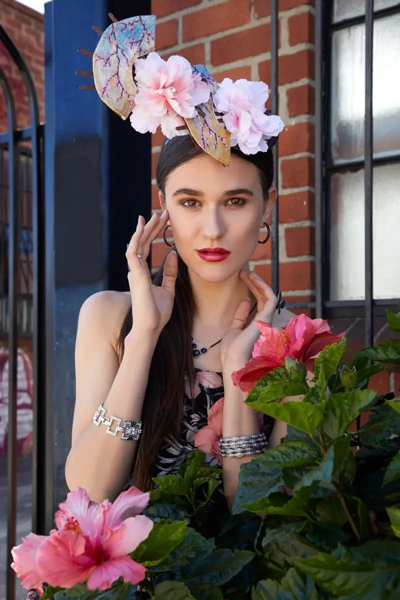 Victoria Henley, black floral jumpsuit and fan fascinator, ivy wall and iron gate, Los Angeles fashion week test shoot, photographed by Scott Parker Photo