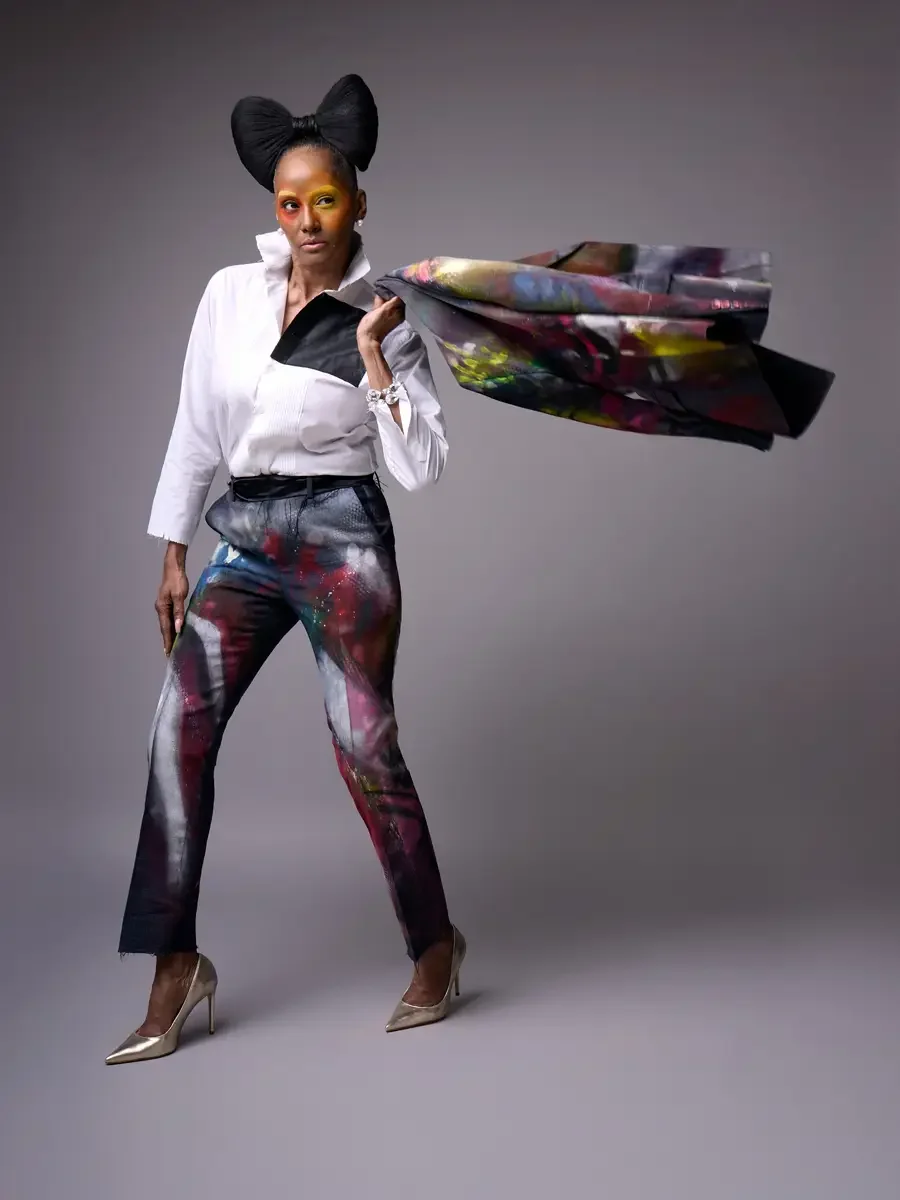JUS10H Met Monday 2026, full-length hand-painted suit, blazer held open, white tuxedo shirt and painted trousers, grey background, photographed by Scott Parker Photo