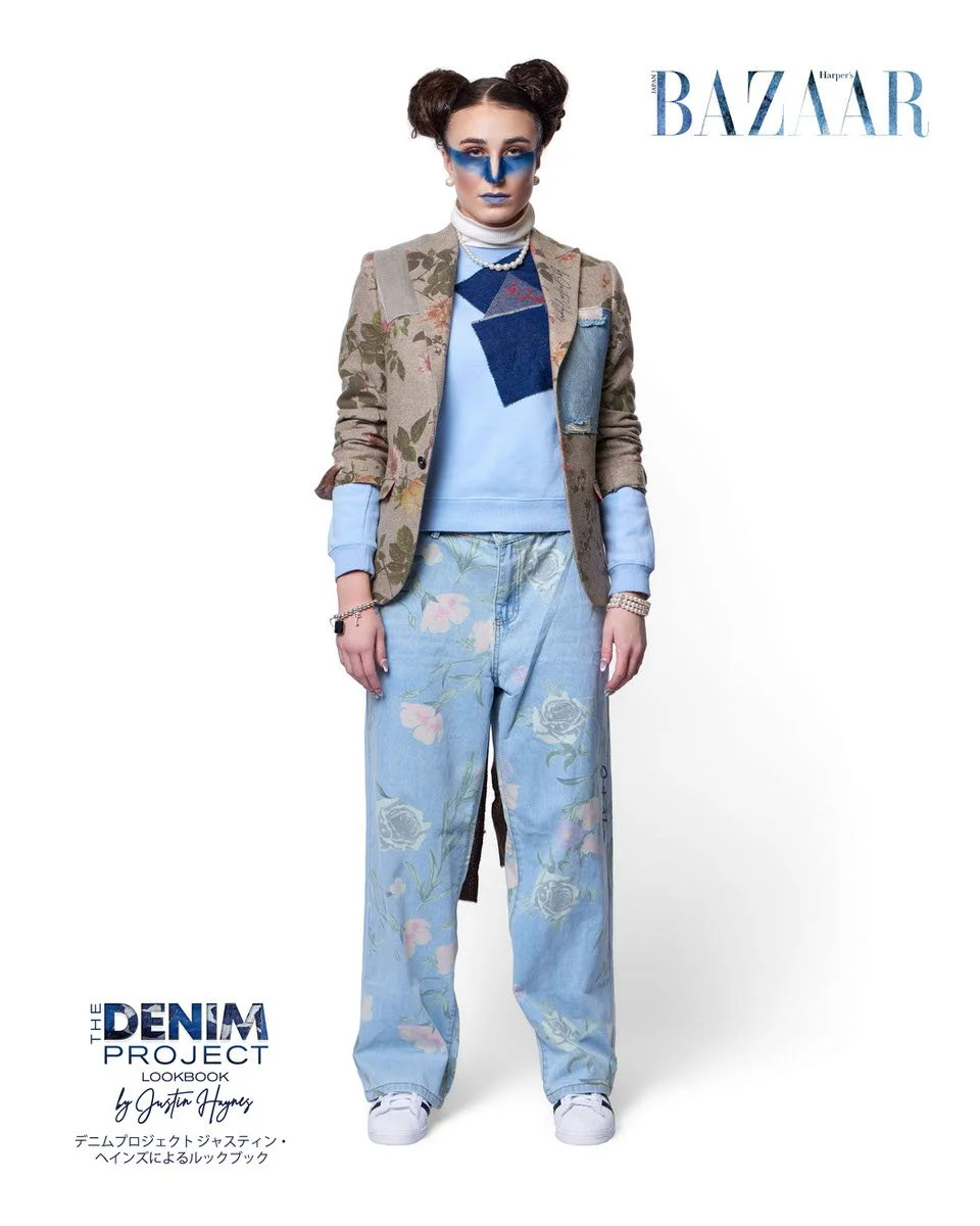JUS10H Denim Project 2025 Harper's Bazaar Japan lookbook — model in botanical floral-print linen blazer with geometric denim and JUS10H script patchwork chest panel over a periwinkle blue crewneck sweatshirt, paired with wide-leg light-wash floral-pr