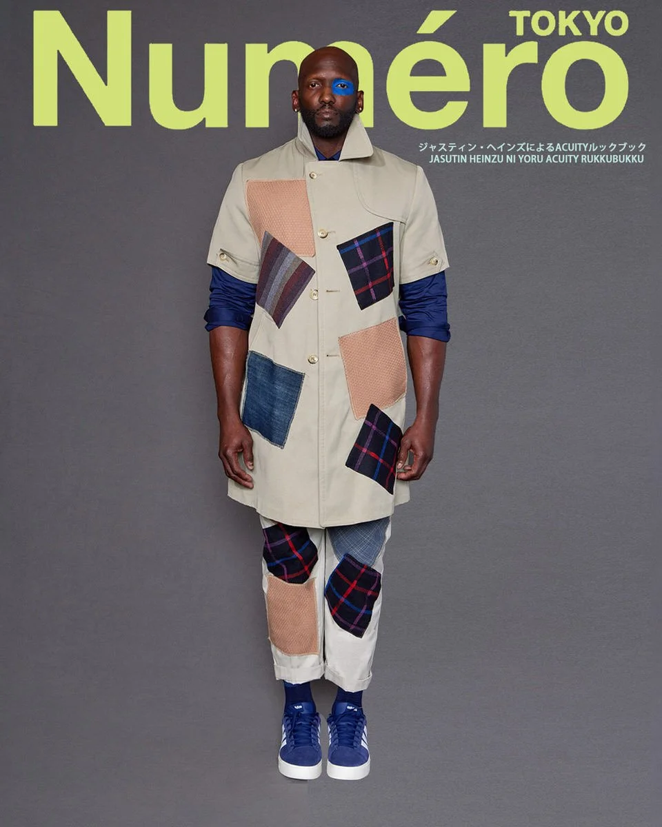 JUS10H by Justin Haynes ACUITY Collection menswear look for Numéro Tokyo by Scott Parker — male model in tan canvas overcoat with multi-fabric plaid, denim, and woven patchwork panels, layered over navy long-sleeve, paired with coordinating patchwork