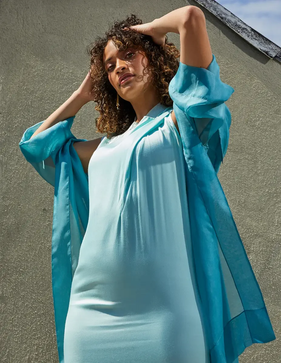 Fashion test shoot, three-quarter, model Ireland T in aqua sleeveless midi dress with turquoise sheer wrap, East Village rooftop, New York City, styling by Matsine Stinson, makeup by Stefani Paige Vivian, photographed by Scott Parker Photo