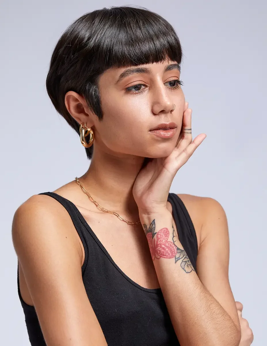 Eloissa, portrait, gold hoop earrings and layered chain necklace, floral forearm tattoo, black tank, East Williamsburg studio test shoot, makeup by Schanica Pickens, photographed by Scott Parker Photo