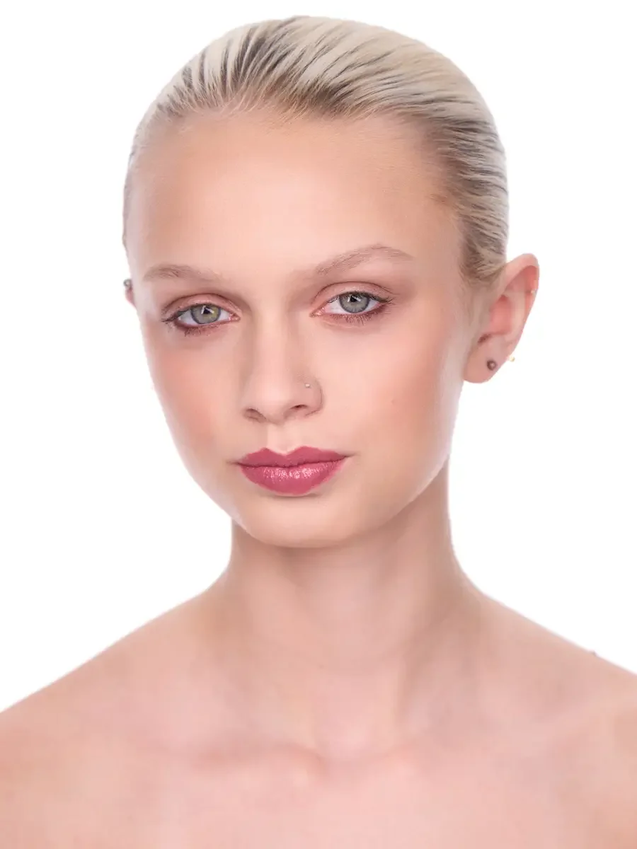 Model portfolio development session, beauty, close-crop, hair slicked back, slight turn, gaze directed left, rose lip, soft eye, bare shoulders, white background, photographed by Scott Parker Photo, New York