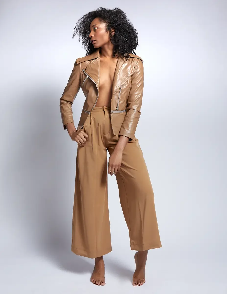 Arielle Chambers, full length, camel patent leather moto jacket and wide-leg trousers, East Williamsburg studio test shoot, makeup by Schanica Pickens, photographed by Scott Parker Photo
