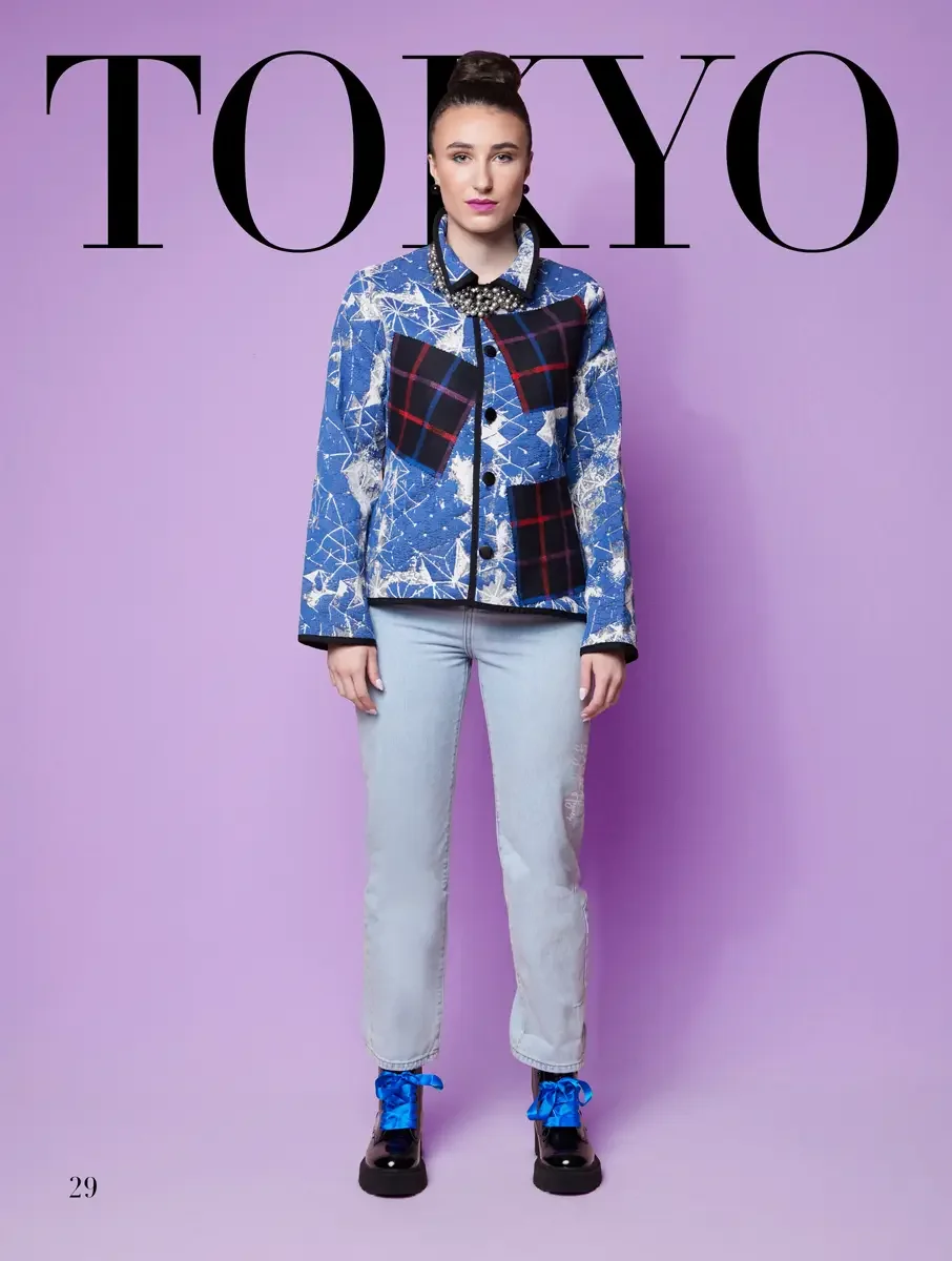 JUS10H 2025 Tokyo lookbook, blue and white star print jacket with tartan patch over pearl collar shirt and pale wash straight leg jeans with blue ribbon lace boots, lavender background, photographed by Scott Parker Photo for the Tokyo Fashion Council