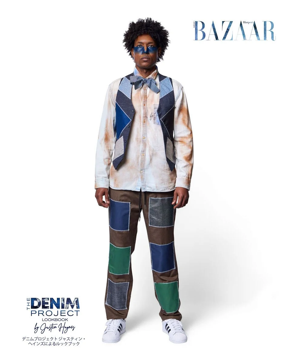 JUS10H Denim Project 2025 Harper's Bazaar Japan lookbook — male model in grey patchwork blazer-style vest with large navy, charcoal, and denim geometric panels over green t-shirt with dark denim crossbody bag, paired with light-wash wide-leg jeans fe