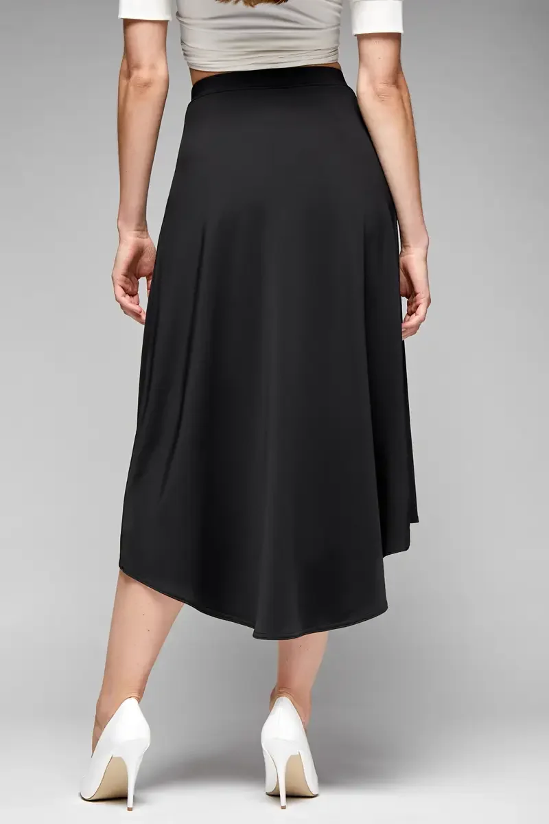 Minika Ko lookbook, black asymmetric midi skirt, back view, flared silhouette, smooth synthetic fabric, paired with white wrap crop top, white pumps, photographed by Scott Parker Photo