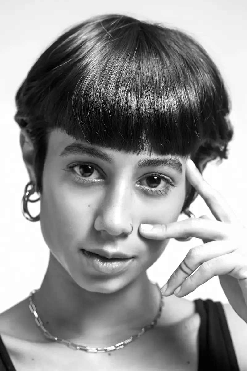 Eloissa, black and white tight beauty portrait, nose ring, gold hoop earring, blunt fringe pixie cut, chain necklace, East Williamsburg studio test shoot, makeup by Schanica Pickens, photographed by Scott Parker Photo