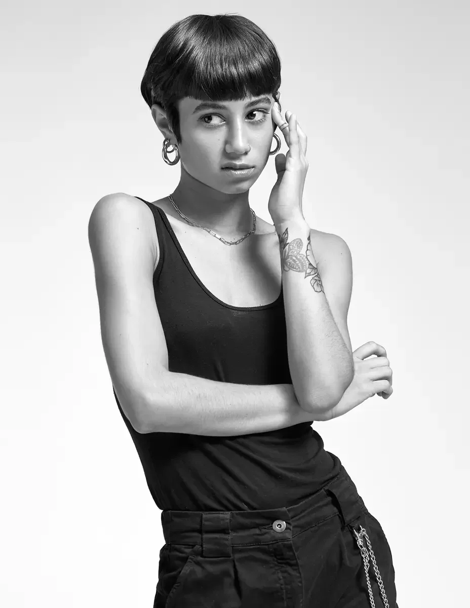Eloissa, black and white portrait, contemplative, chain necklace, gold hoop earrings, pixie cut with blunt fringe, East Williamsburg studio test shoot, makeup by Schanica Pickens, photographed by Scott Parker Photo