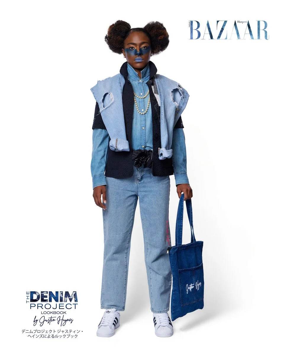 JUS10H Denim Project 2025 Harper's Bazaar Japan lookbook — model in layered light-wash denim shirt under distressed sleeveless light-wash denim vest with raw-cut armholes, carrying a dark indigo JUS10H branded canvas tote bag, light-wash straight-leg