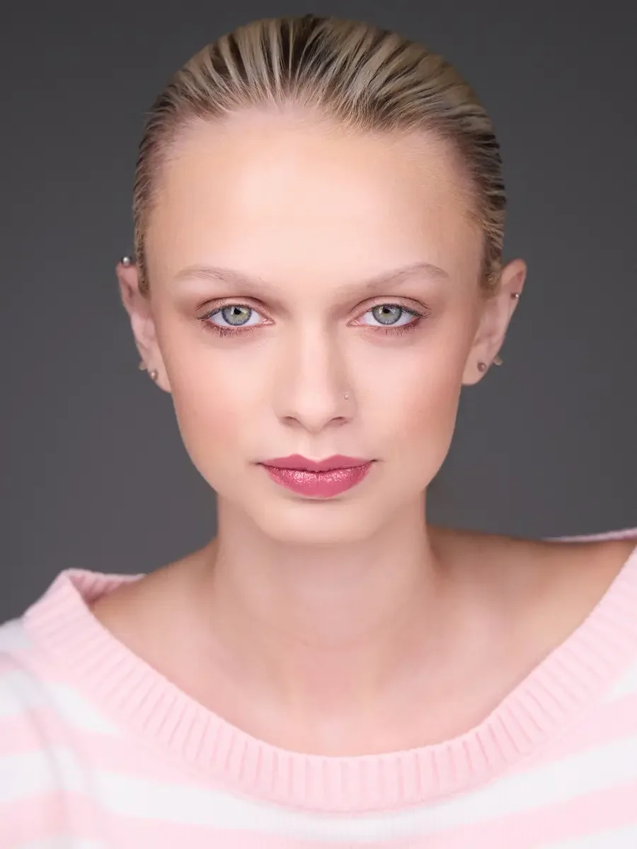 Model portfolio development session, beauty, close-crop, hair slicked back, face forward, direct gaze, rose lip, soft eye, pink striped sweater, gray background, photographed by Scott Parker Photo, New York
