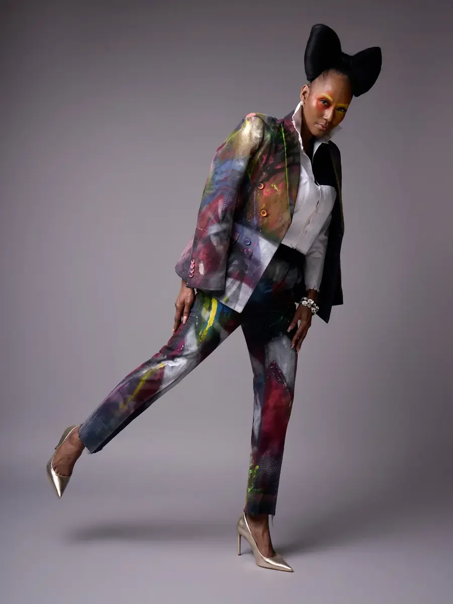 JUS10H Met Monday 2026, full-length hand-painted suit open with white tuxedo shirt, in motion, grey background, photographed by Scott Parker Photo