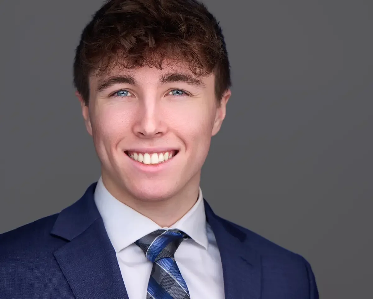 Professional headshot, navy suit and blue patterned tie, gray background, Greater Hartford Connecticut, photographed by Scott Parker Photo
