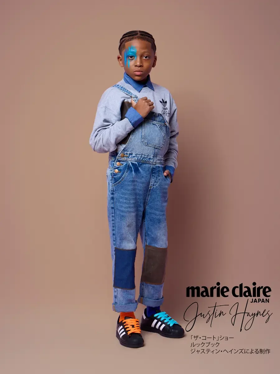 Kids denim overalls over a sweatshirt and collared denim shirt, hand at strap, JUS10H Court Show lookbook