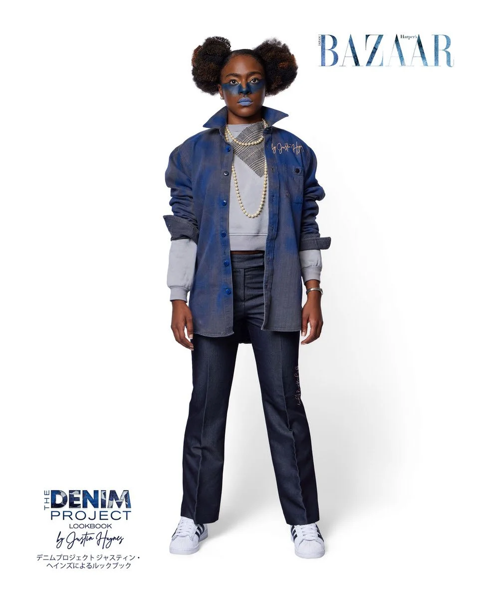 JUS10H Denim Project 2025 Harper's Bazaar Japan lookbook — model in oversized indigo-washed denim shirt-jacket with JUS10H signature embroidery over cropped grey sweatshirt, layered pearl necklace, dark slim-leg trousers with embroidered script detai