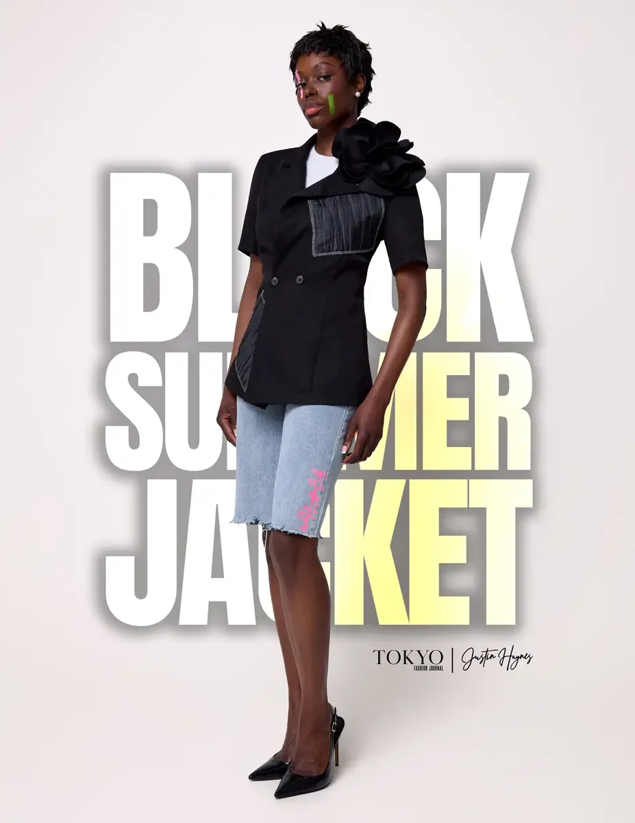 JUS10H Black Summer Jacket lookbook, female model in black double-breasted blazer with oversized floral corsage and gray denim patchwork panel, light-wash denim bermuda shorts with JUS10H logo, black slingback heels, white background, photographed by