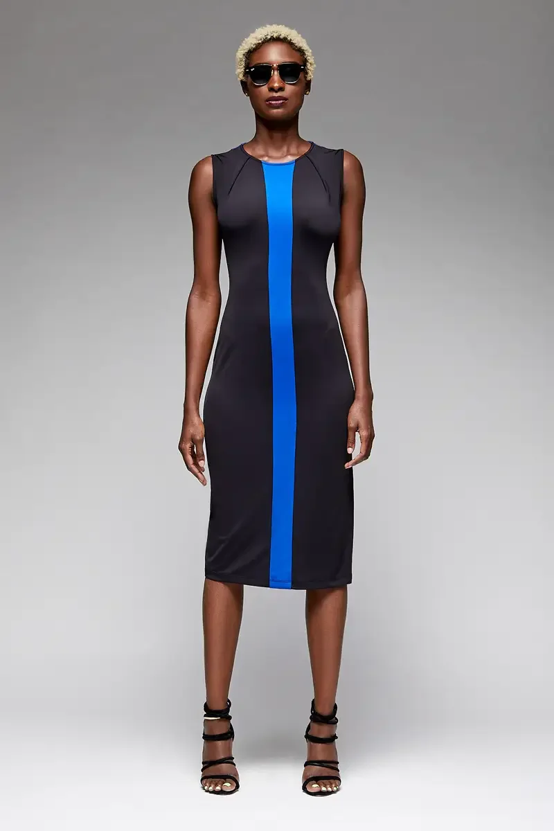 Minika Ko lookbook, black and cobalt blue colorblock bodycon midi dress, front view, dark sunglasses, vertical cobalt blue center panel, angled seam detail at shoulder, smooth synthetic fabric, photographed by Scott Parker Photo