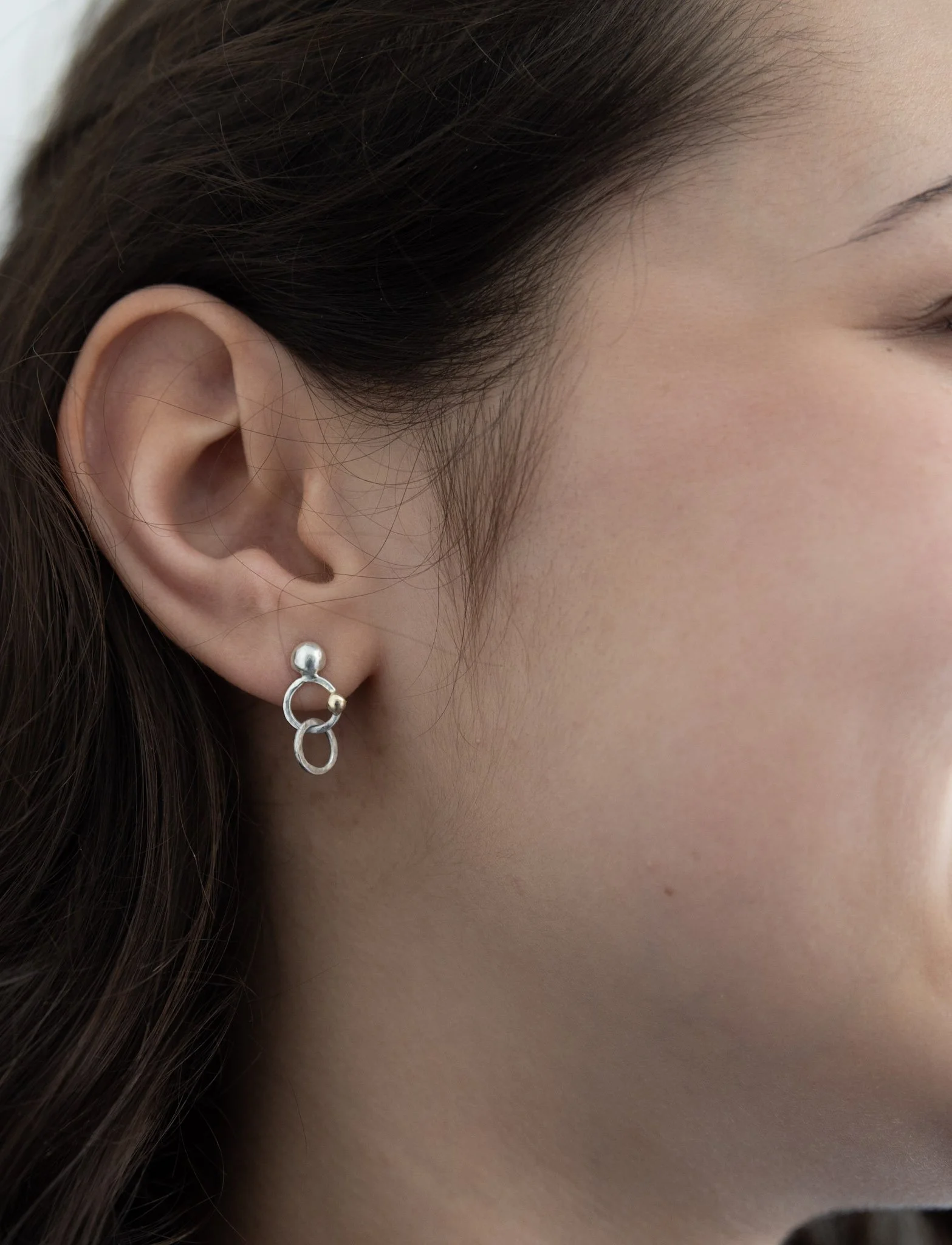 Silver "Minerva" stud earrings, hammer-textured interlinked hoops with gold detail