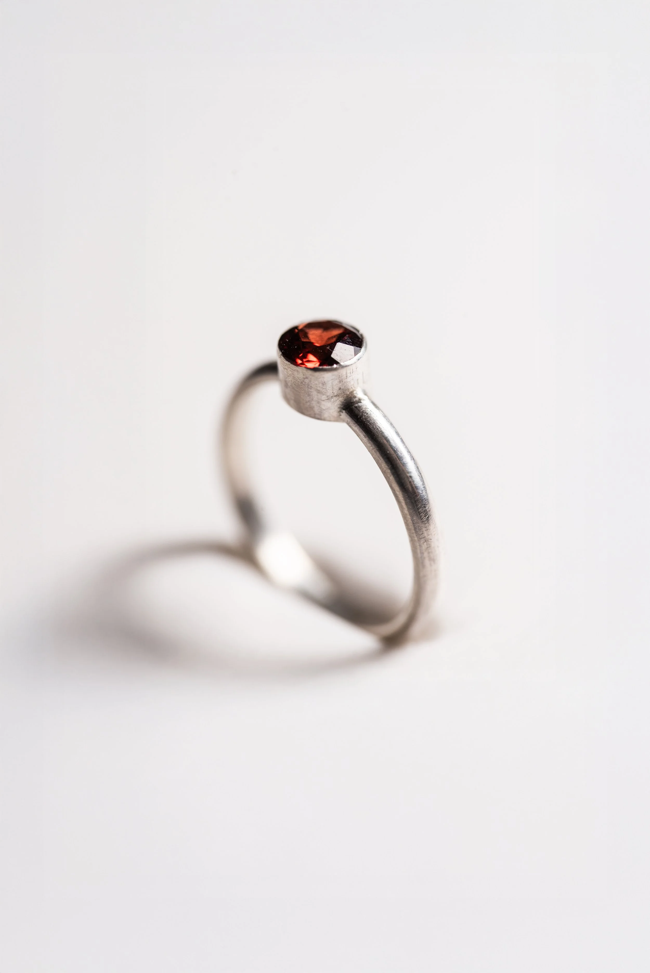 Silver ring, 5mm faceted garnet, tube-set stone