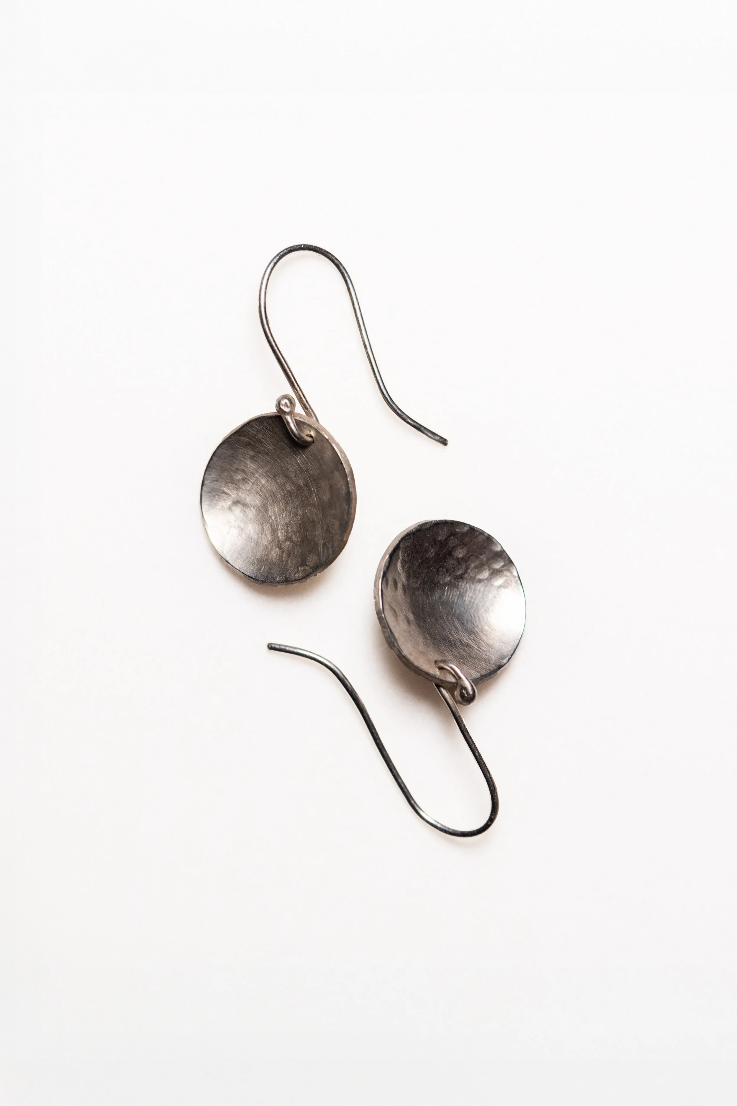 Silver earrings, hammer-textured domed discs