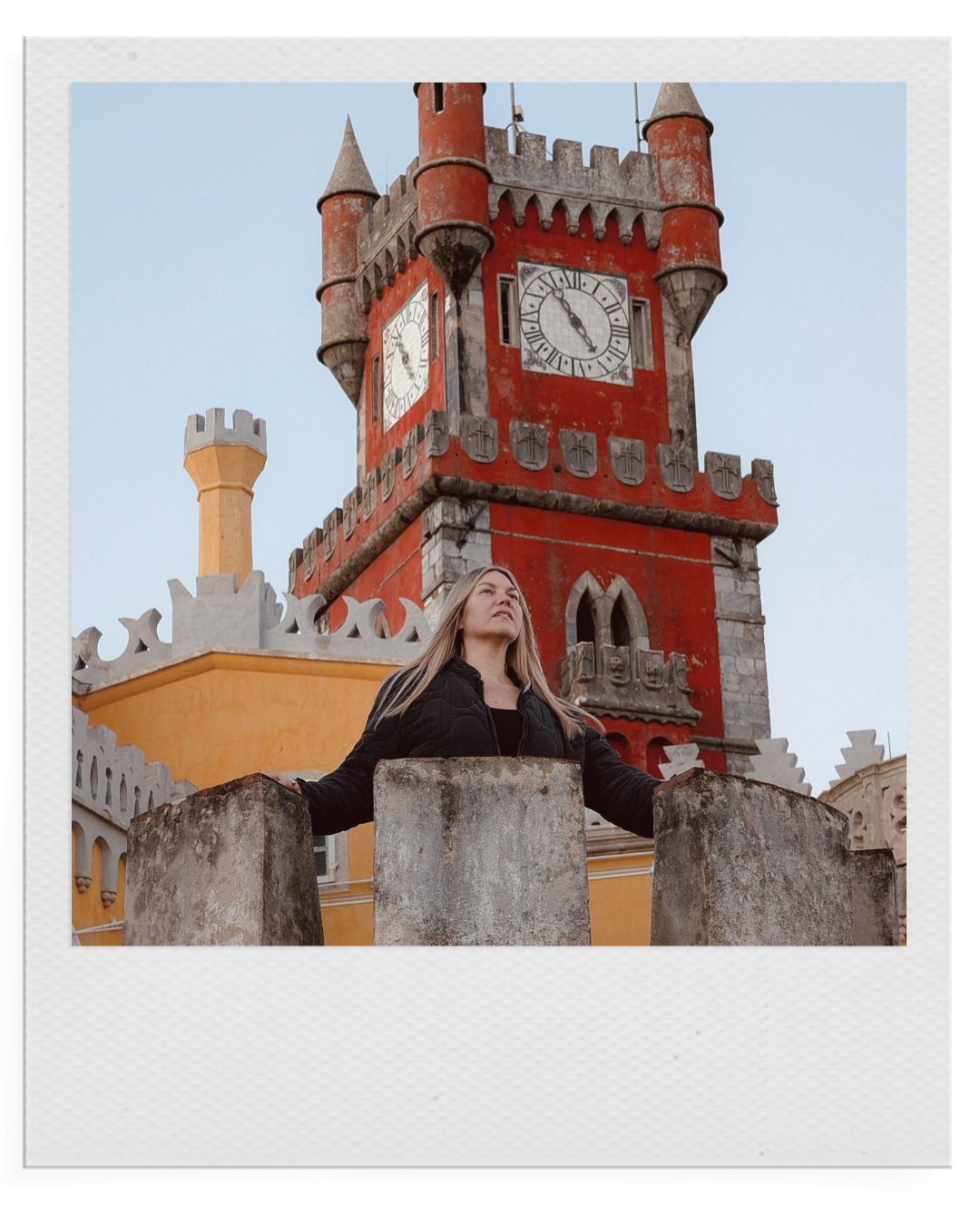 Anna Johnson standing on a balcony overlooking a historic European town.