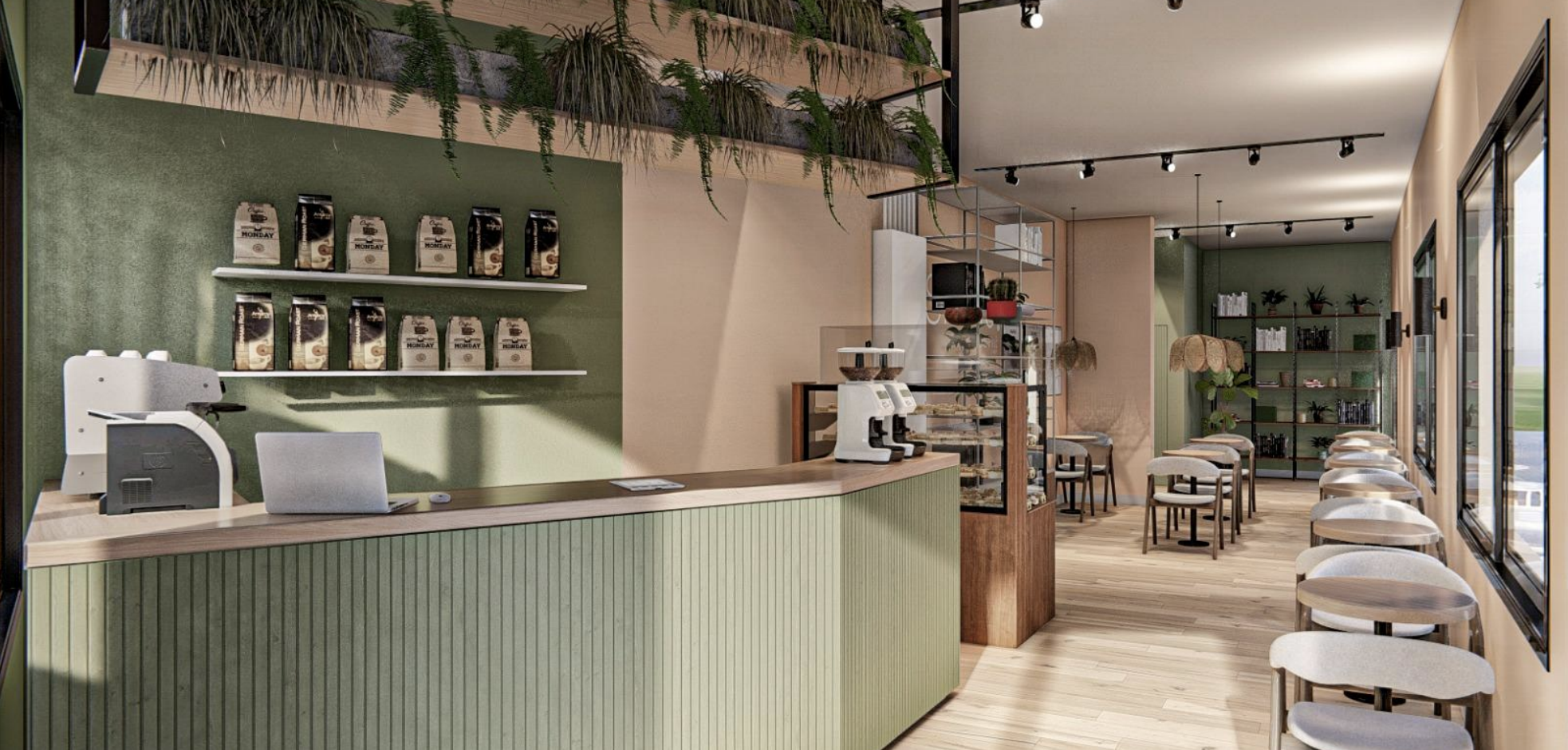 Interior de una cafetería moderna con mostrador de madera verde, máquina de café, estanterías con libros y plantas, y mesas con sillas, cerca de ventanas grandes que dejan pasar luz natural.