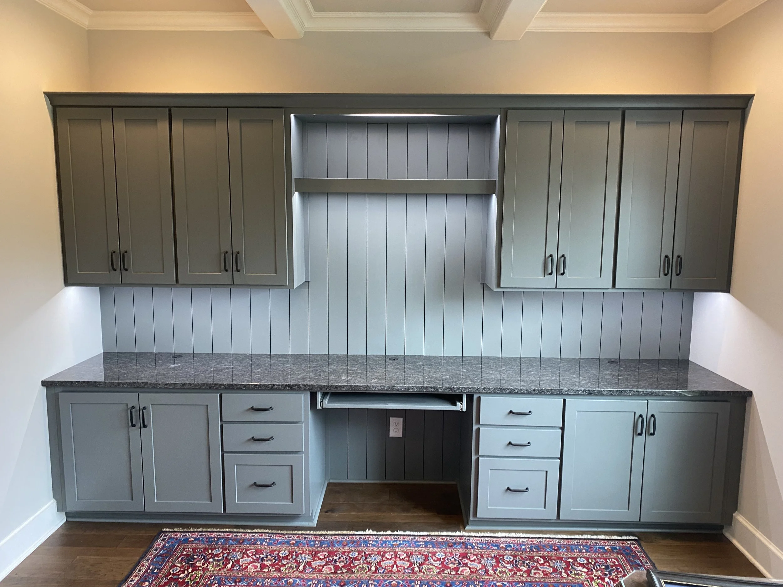 Custom office built-ins with lights, charging drawer, and vertical shiplap.