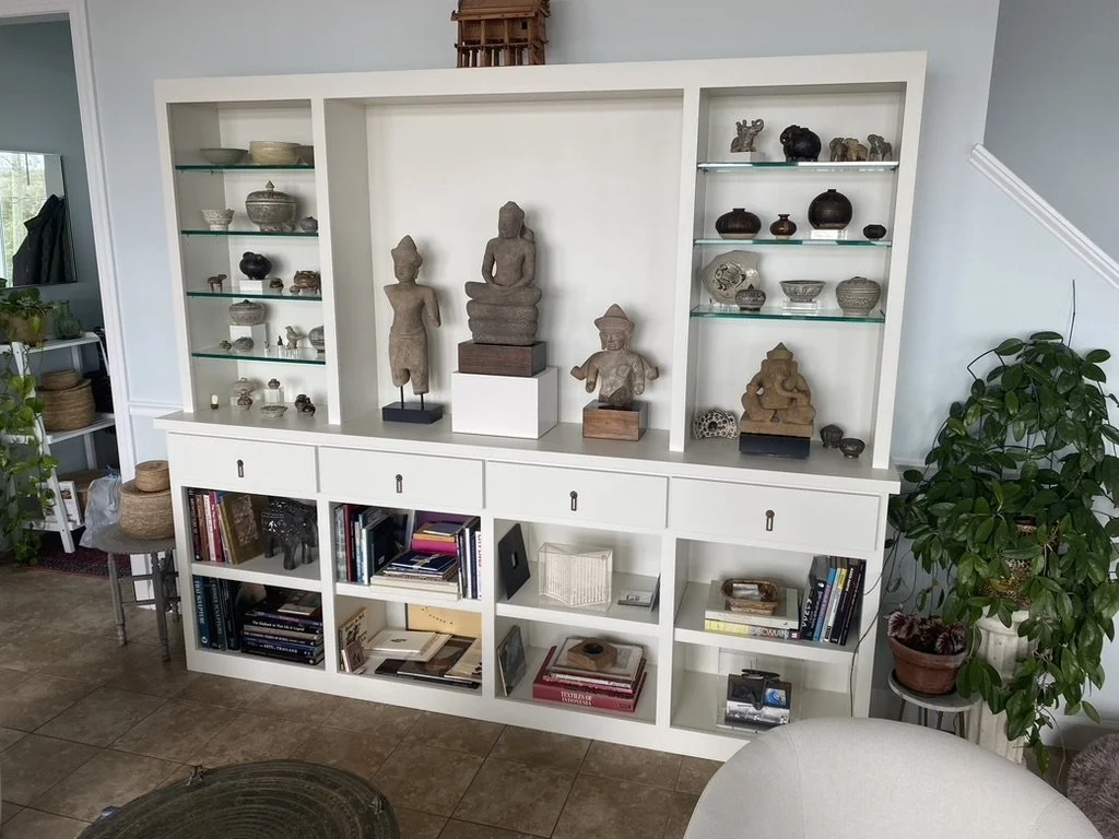 Custom built-in display cabinets with lights and glass shelving.
