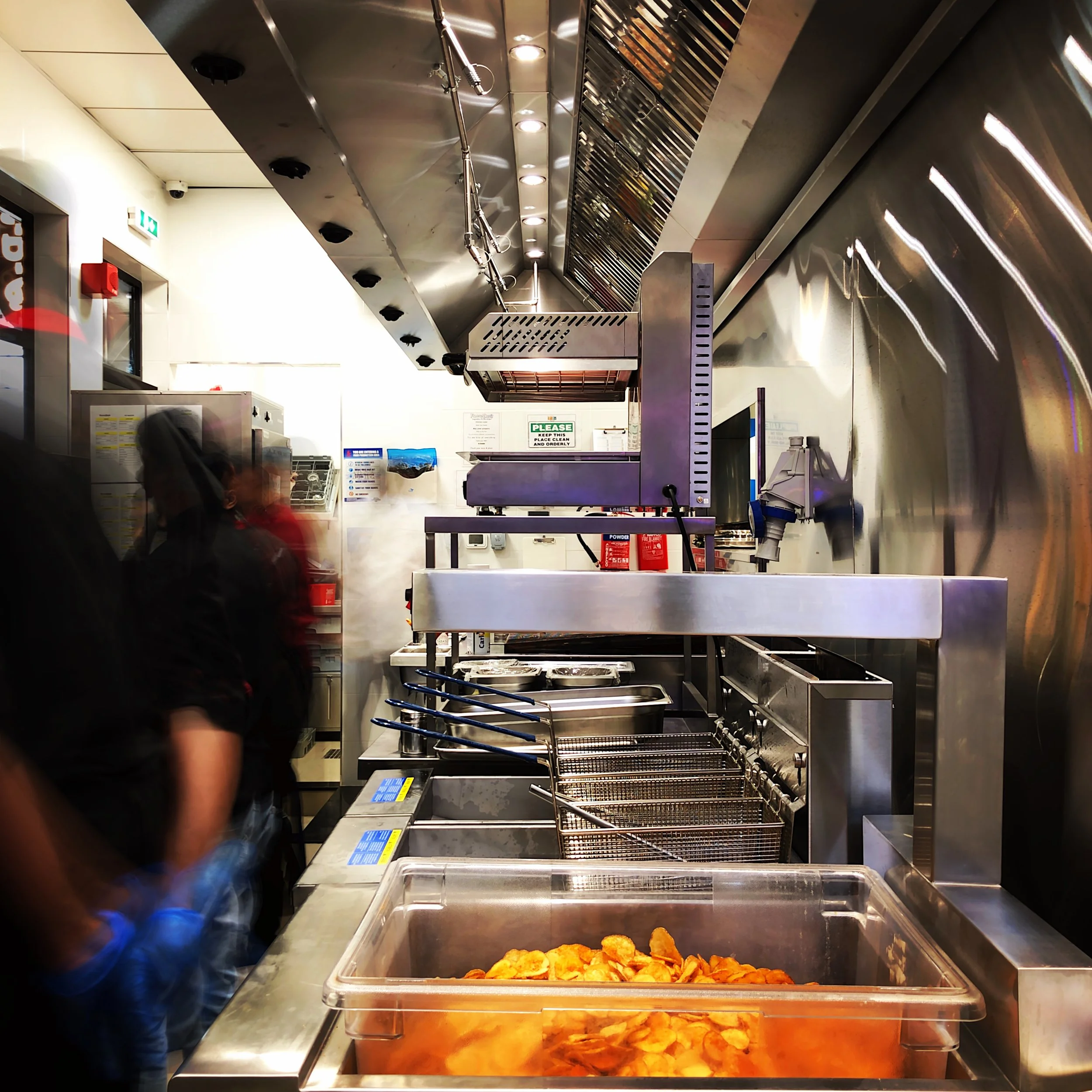 View of kitchen cooking line from an early kitchen project by Cleresdyne