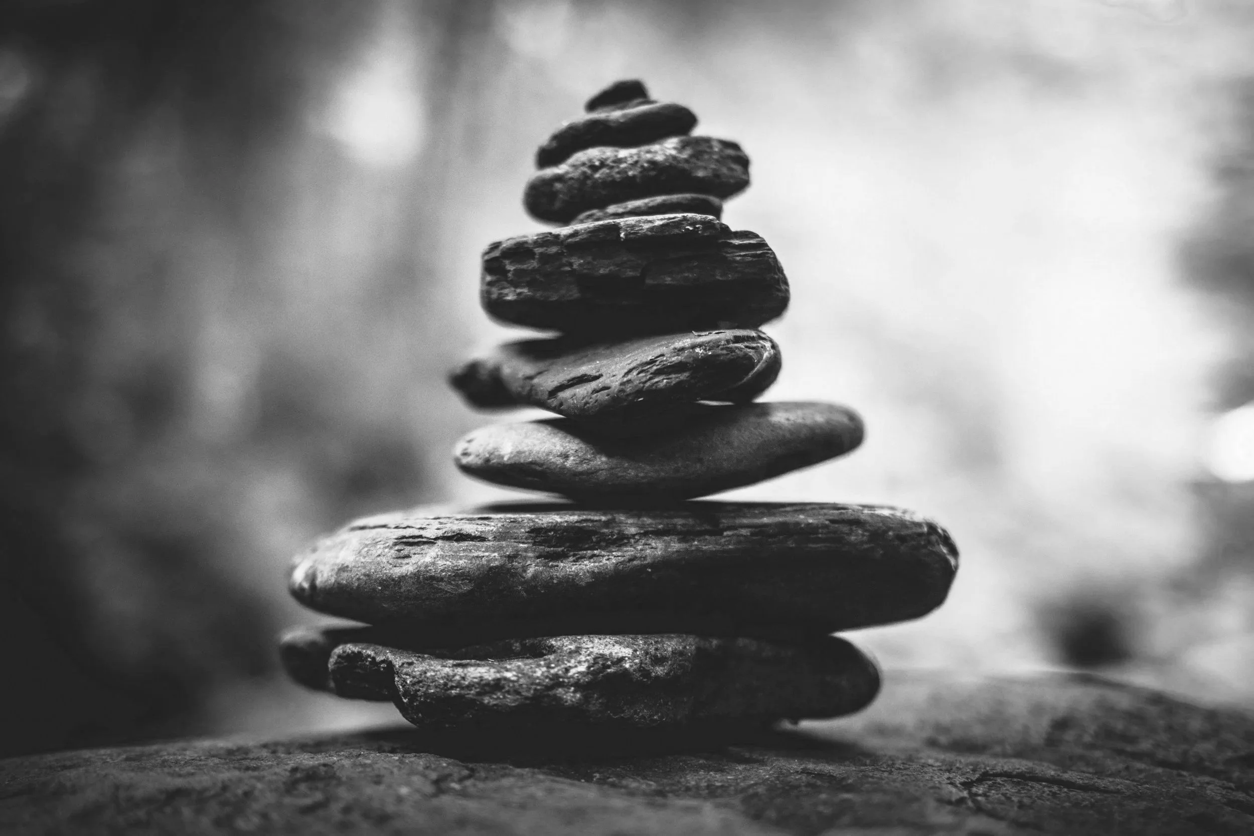 Stacked rocks in a monochrome photograph with a blurred background.