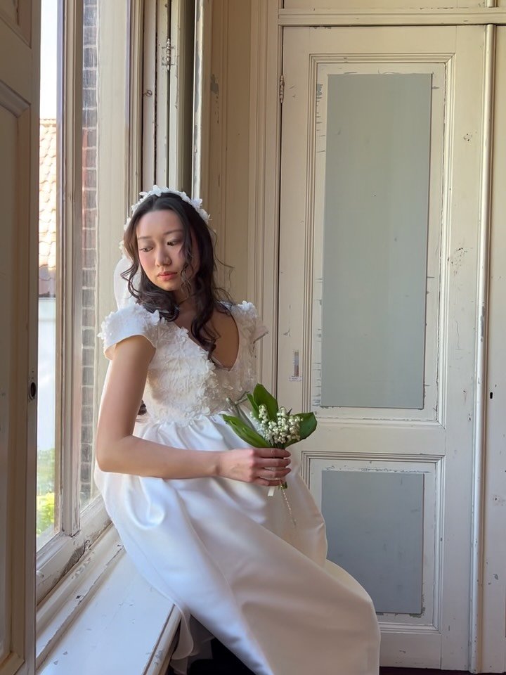 SS26 Wedding Attire 

Look 7: The Wedding gown. 60s inspired dress, made from thick mikado fabric, combined with lace bustier which has fabric made calla flowers. 
Gown is styled with chiffon veil which is hand embroidered.
Muguet bouquet makes the l