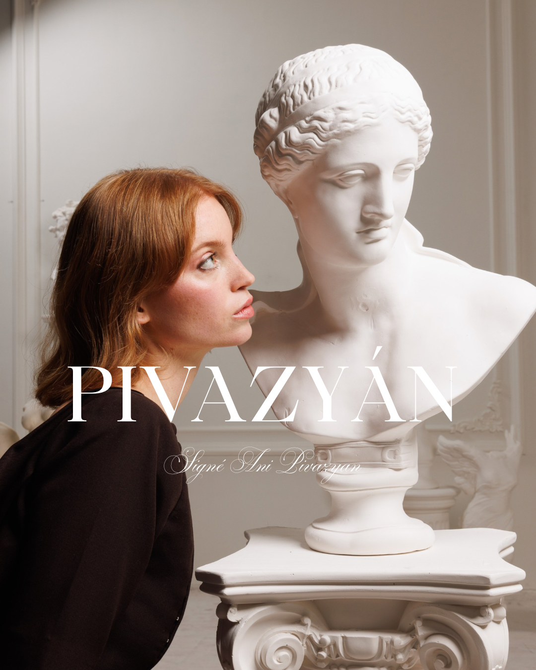 A woman with red hair looking at a classical white marble bust sculpture of a woman in a museum or gallery setting