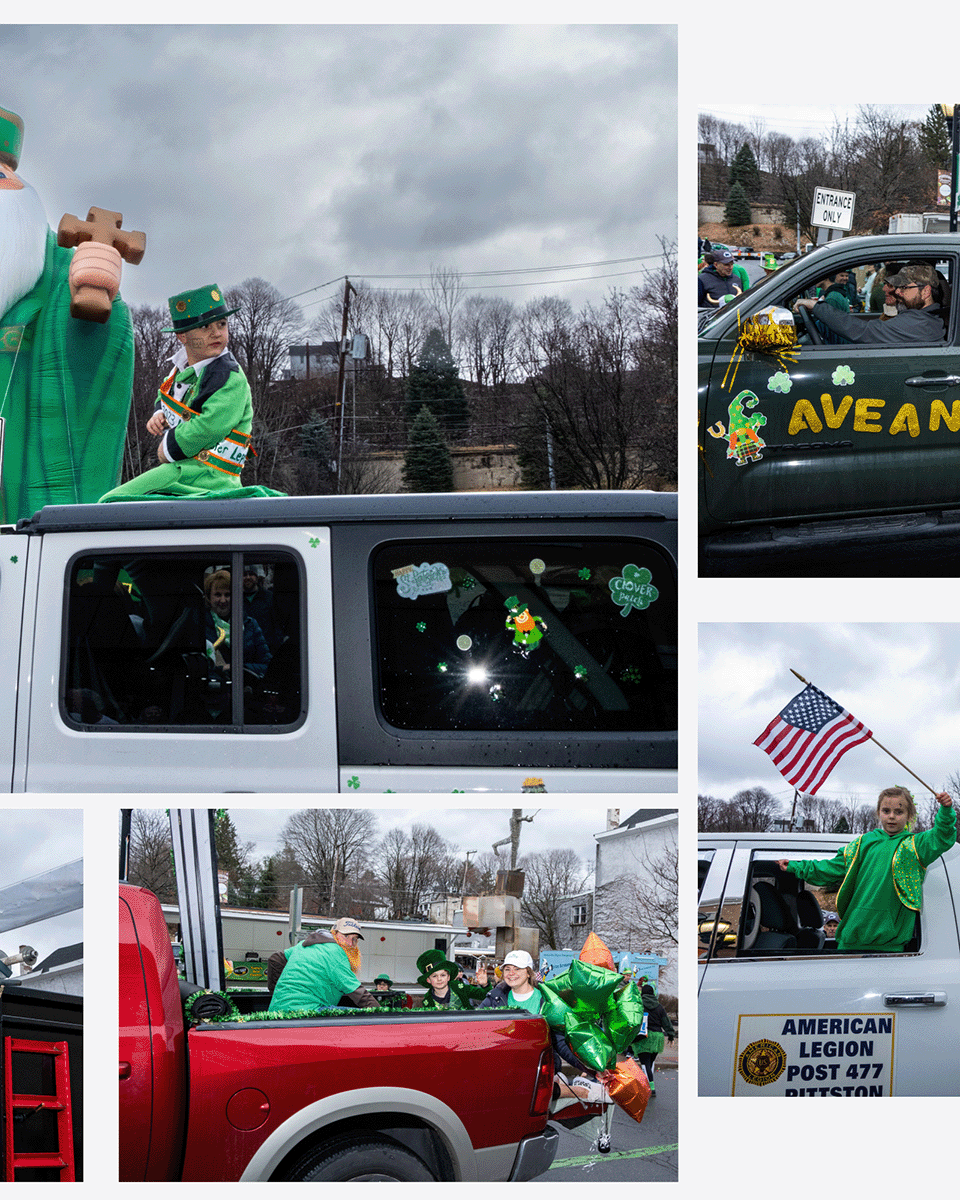 Parade float and pickup truck decorated for St. Patrick's Day, with children and adults wearing green, holding flags, and festive decorations.
